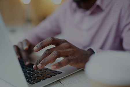 A person typing on a laptop computer.